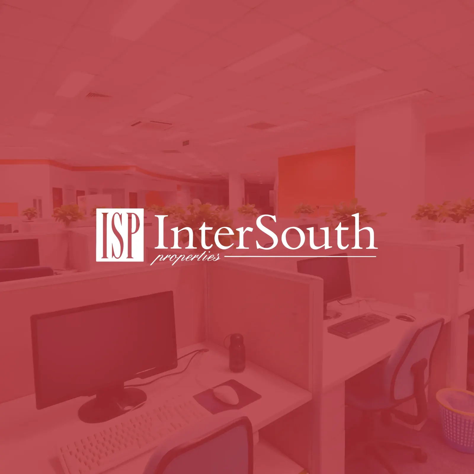 InterSouth Properties logo with ISP monogram in white over a red-tinted photo of an open office with cubicles and computer monitors